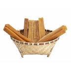 Bamboo basket filled with large dried yellowish-brown natural resin sticks