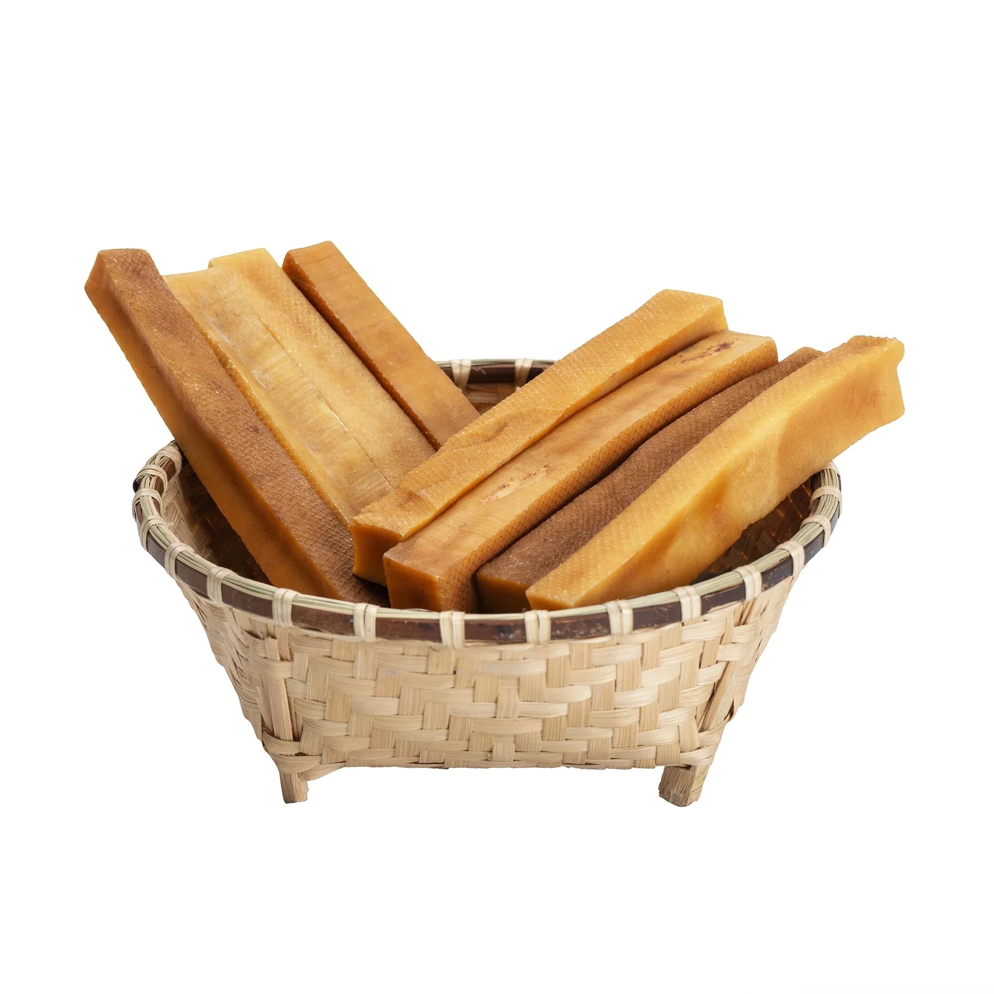 Bamboo basket filled with raw dried chhurpi cheese sticks on white background