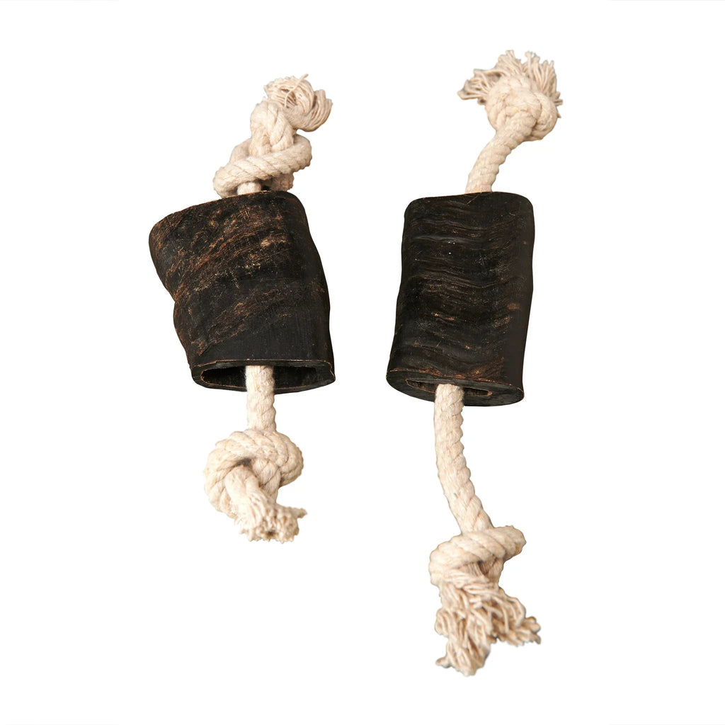 Two black natural rubber dog chew toys with knotted white cotton rope ends on a white background