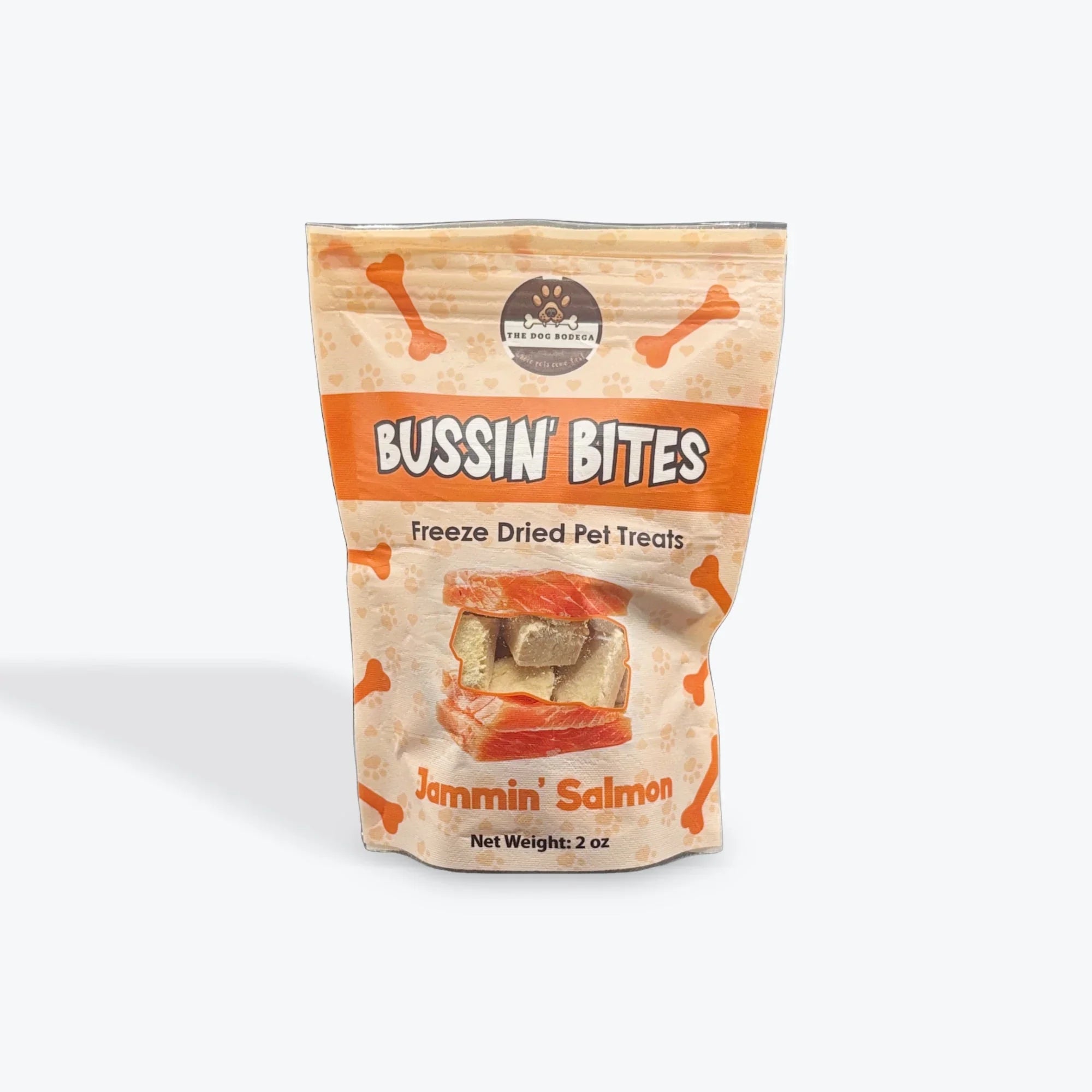 Bussin' Bites Jammin' Salmon freeze dried pet treats in 2 oz beige and orange bag with bone graphics