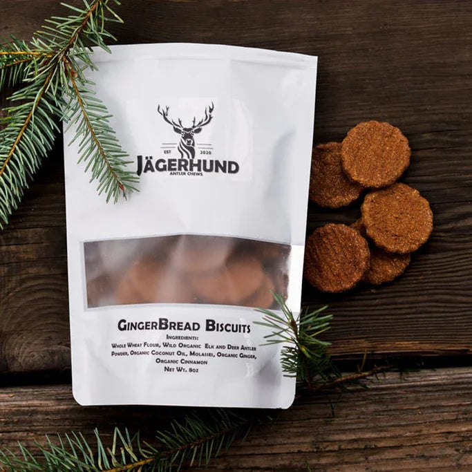 Jägerhund Gingerbread Biscuits dog treats next to pine branches on rustic wood surface
