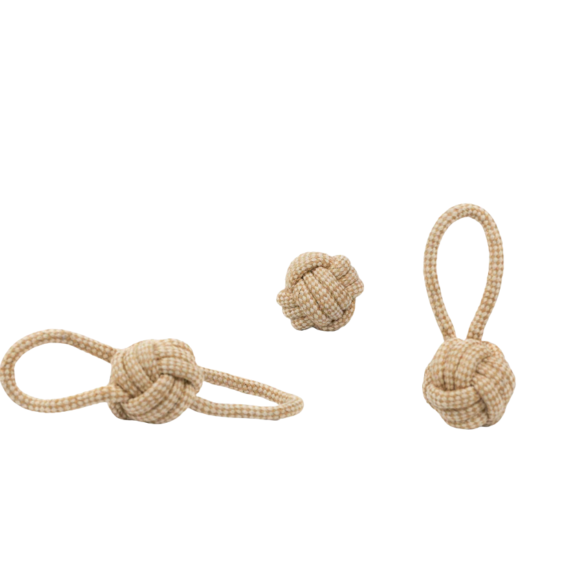 Two beige rope toys with knots on a white background