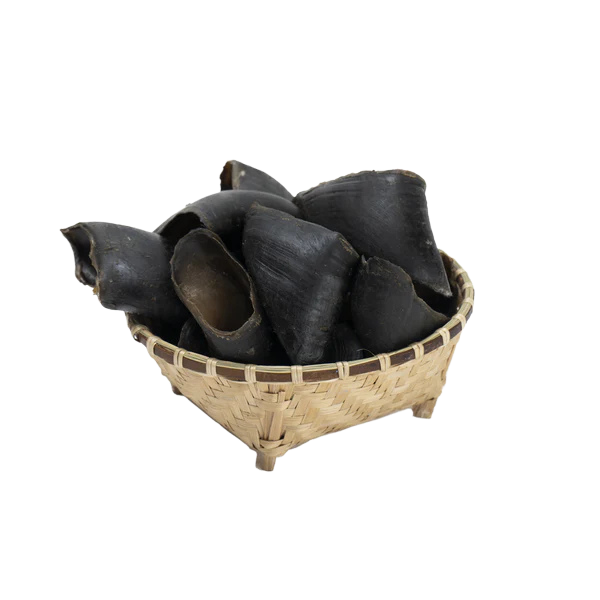 Water Buffalo Hooves Dog Chews in a woven basket on a white background.
